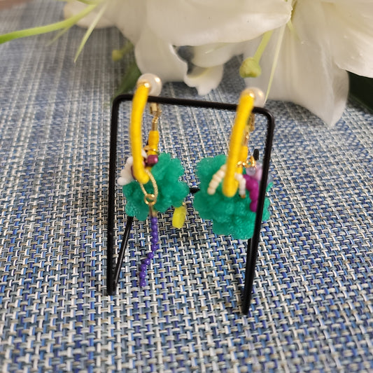 Colorful beaded hair clip on a textured fabric background