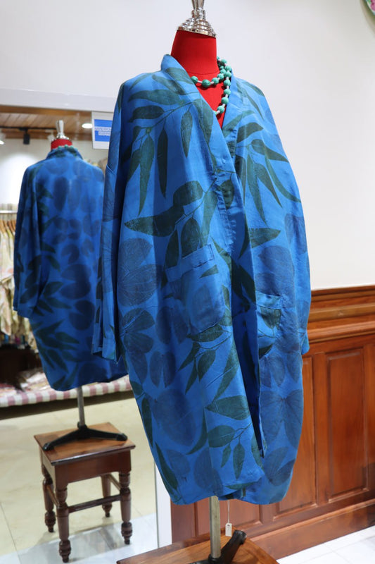 Blue patterned garment on a mannequin in a store setting
